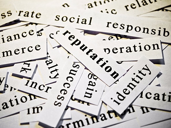 selection of white cards printed with terms such as social responsibility, identity, and reputation